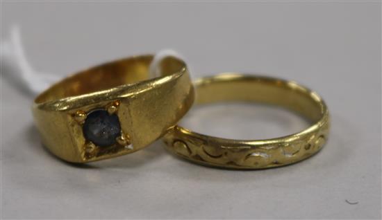 An 18ct yellow gold wedding ring with carved decoration and a yellow metal ring 10.3g gross